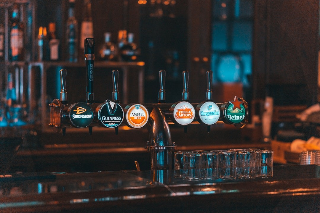 a row of beer taps sitting on top of a bar